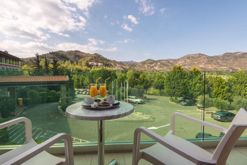 rodon hotel veranda overlooking the tennis courtin Agros Cyprus