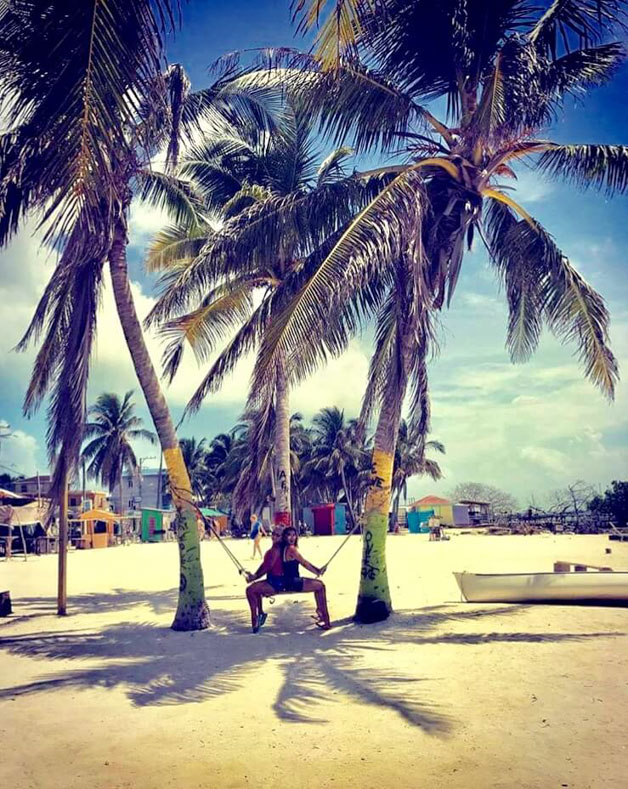 me and my best friend sitting on a swing on one of the 45o cayes in Belize - Belize fun facts 