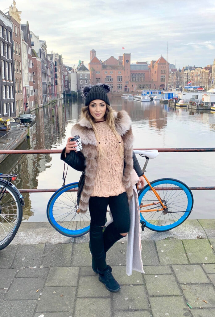 me during my Amsterdam Solo Travel trip in front of the canal 