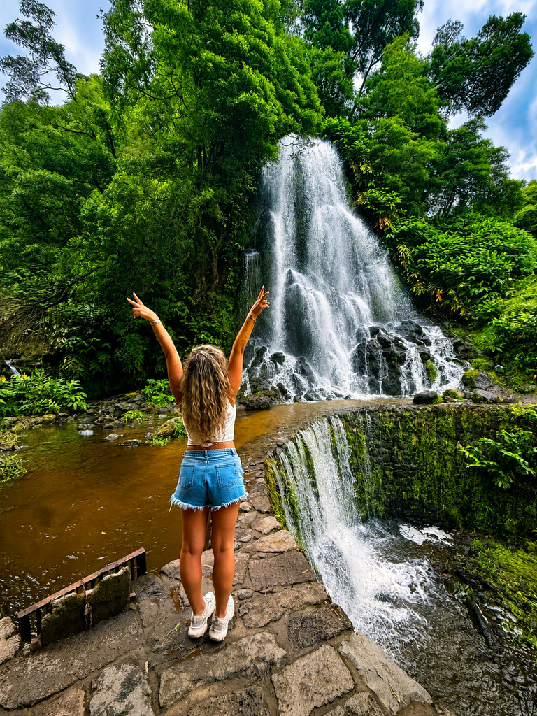 Ribeira dos Caldeirões waterfall surrounded by lush greenery in São Miguel, Azores